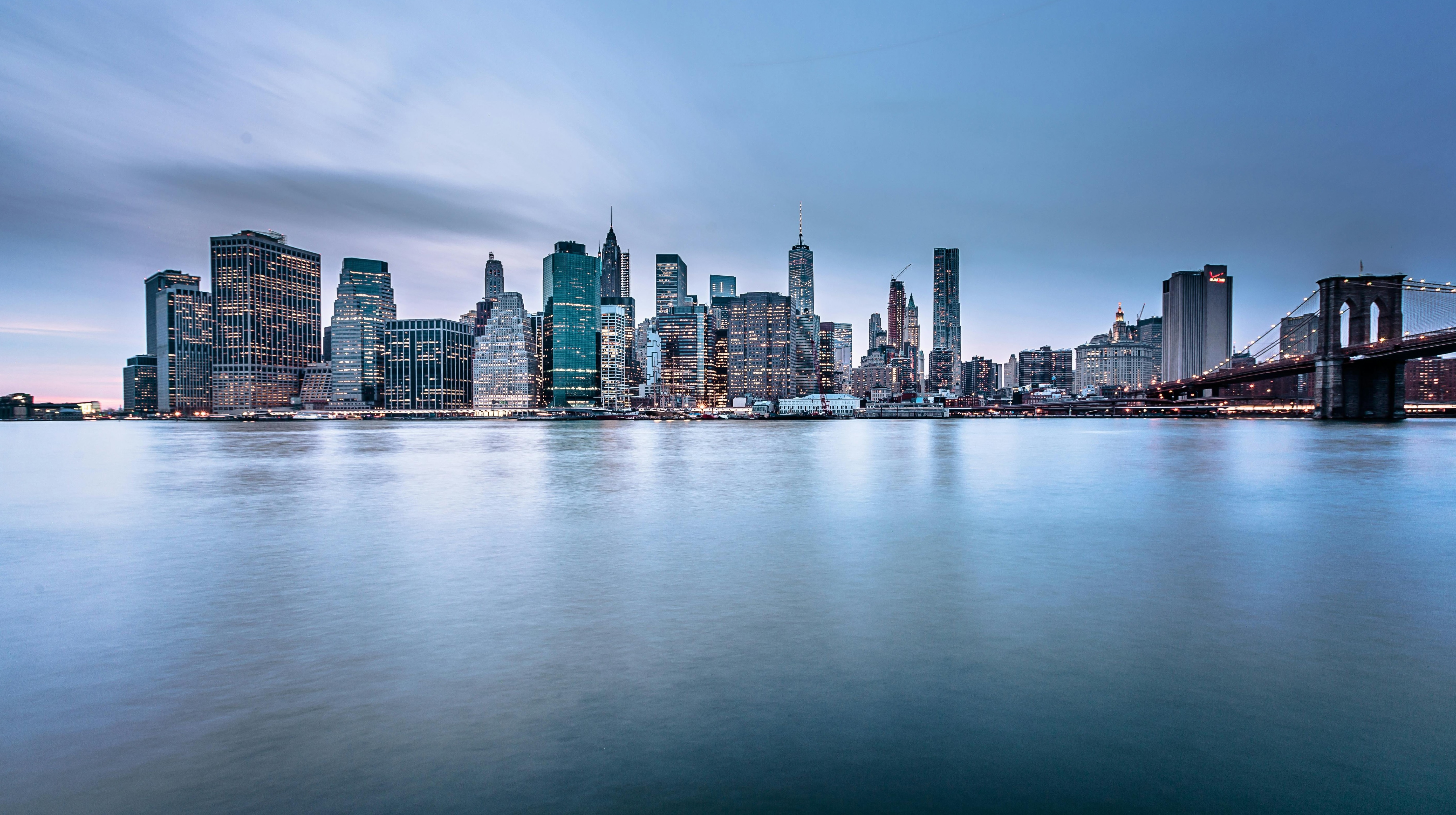 New York City skyline at dusk with Brooklyn Bridge